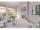 Living room with a fireplace, light-colored walls, and large window with view to the backyard at 11664 E Del Timbre Dr, Scottsdale, AZ 85259