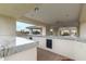 This covered outdoor kitchen has a granite countertop and offers great views of the community at 11664 E Del Timbre Dr, Scottsdale, AZ 85259