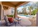 Outdoor living space has pool views, comfortable seating, and inviting patio at 11664 E Del Timbre Dr, Scottsdale, AZ 85259