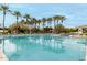 A pristine pool with lane markers surrounded by palm trees and lounge chairs in a community at 11664 E Del Timbre Dr, Scottsdale, AZ 85259