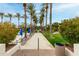 Beautiful pool area with lounge chairs and a palm tree lined walkway at 11664 E Del Timbre Dr, Scottsdale, AZ 85259