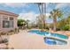 Beautiful backyard pool and spa area with desert landscaping and mature palm trees at 11664 E Del Timbre Dr, Scottsdale, AZ 85259