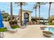Community pool with lounge chairs, seating, and manicured landscaping under sunny skies at 11664 E Del Timbre Dr, Scottsdale, AZ 85259