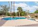 An inviting backyard pool and spa surrounded by desert landscaping and mature palm trees at 11664 E Del Timbre Dr, Scottsdale, AZ 85259