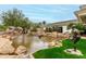 Artistic outdoor water feature with bronze sculptures and lush landscaping at 11664 E Del Timbre Dr, Scottsdale, AZ 85259