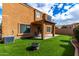 Cozy backyard with synthetic grass, covered patio and a modern firepit at 12462 N 75Th Ln, Peoria, AZ 85381