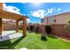 Manicured synthetic grass, landscaping, modern firepit and covered patio at 12462 N 75Th Ln, Peoria, AZ 85381