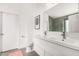 Modern bathroom with double sinks, large mirror, and sleek white cabinetry offering ample storage at 12462 N 75Th Ln, Peoria, AZ 85381