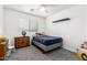 Comfortable bedroom with natural light, plush carpeting, and a minimalist design for serene living at 12462 N 75Th Ln, Peoria, AZ 85381