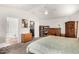 Spacious primary bedroom featuring a ceiling fan, desk area, and ensuite bathroom for added convenience at 12462 N 75Th Ln, Peoria, AZ 85381