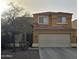 Exterior elevation of a two-story home with a two car garage and desert landscaping at 12462 N 75Th Ln, Peoria, AZ 85381