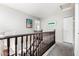 Upper-level hallway with carpet and wood railing at 12462 N 75Th Ln, Peoria, AZ 85381