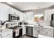 Clean kitchen showcasing white cabinets, stainless steel appliances, and white subway tile backsplash at 12462 N 75Th Ln, Peoria, AZ 85381