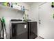 Laundry room area featuring a new washer and dryer next to a storage shelf and door at 12462 N 75Th Ln, Peoria, AZ 85381