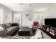 Inviting living room features dark wood floors, neutral walls, and comfortable seating arrangements at 12462 N 75Th Ln, Peoria, AZ 85381
