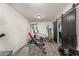 Finished basement with home gym equipment and modern barn door at 1253 E Avila Ave, Casa Grande, AZ 85122