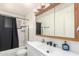 Bright bathroom with white vanity, black hardware, and tiled shower at 1253 E Avila Ave, Casa Grande, AZ 85122