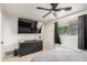 A well-lit bedroom features a ceiling fan and modern media center at 1253 E Avila Ave, Casa Grande, AZ 85122