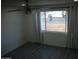 Well-lit bedroom with a ceiling fan, gray wood floors and a window providing natural light at 1253 E Avila Ave, Casa Grande, AZ 85122