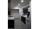 Modern kitchen with white appliances, dark cabinets, stylish backsplash, and luxury vinyl plank flooring at 1253 E Avila Ave, Casa Grande, AZ 85122