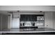 Modern kitchen featuring black cabinetry, white appliances, and a kitchen island with bar seating at 1253 E Avila Ave, Casa Grande, AZ 85122