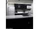 Cozy kitchen featuring white appliances, black cabinets, stylish backsplash, island, and pendant lighting at 1253 E Avila Ave, Casa Grande, AZ 85122