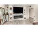Chic living area with a modern fireplace, custom built-ins, sleek flooring and minimalist design at 1253 E Avila Ave, Casa Grande, AZ 85122