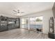 Bright living space with a view of the pool through sliding glass doors, complemented by modern decor and sleek flooring at 1253 E Avila Ave, Casa Grande, AZ 85122