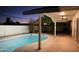 This backyard features a covered patio area, a pool and a privacy fence, perfect for outdoor enjoyment at 1253 E Avila Ave, Casa Grande, AZ 85122