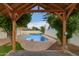 Inviting pool area featuring a shaded patio and well-maintained landscaping, perfect for outdoor relaxation and enjoyment at 1253 E Avila Ave, Casa Grande, AZ 85122