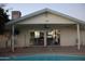 This backyard features a sparkling pool, a covered patio area, and large sliding glass doors at 1253 E Avila Ave, Casa Grande, AZ 85122