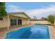 Private backyard oasis with a sparkling blue pool and covered patio at 1253 E Avila Ave, Casa Grande, AZ 85122