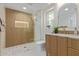 Modern bathroom featuring a beautiful vanity, gold hardware, and a glass-enclosed shower at 13038 W Butterfield Dr, Sun City West, AZ 85375