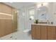 Modern bathroom featuring a beautiful vanity, gold hardware, and a glass-enclosed shower at 13038 W Butterfield Dr, Sun City West, AZ 85375