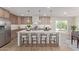 Modern kitchen with stainless steel appliances, marble countertops, and a center island with barstool seating at 13038 W Butterfield Dr, Sun City West, AZ 85375