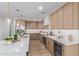 Modern kitchen featuring stainless steel appliances, a wine fridge, and marble countertops at 13038 W Butterfield Dr, Sun City West, AZ 85375