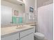 Bathroom with a vanity sink, large mirror, and shower with white curtain at 13642 N Silverbell Dr, Sun City, AZ 85351