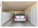 A tidy carport with a silver sedan parked inside, offering convenient covered parking at 13642 N Silverbell Dr, Sun City, AZ 85351