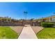 Gated Gail Court community entrance with lush landscaping, offering security and a welcoming atmosphere at 13642 N Silverbell Dr, Sun City, AZ 85351