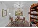 Elegant dining area featuring a glass-topped table, floral chairs, and a stylish chandelier at 13642 N Silverbell Dr, Sun City, AZ 85351