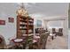 Inviting dining area with a glass table, comfortable chairs, and a spacious living area nearby at 13642 N Silverbell Dr, Sun City, AZ 85351