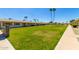 A well-manicured lawn with a sidewalk in front of several apartment units, creating curb appeal at 13642 N Silverbell Dr, Sun City, AZ 85351