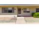 Inviting single-story home featuring a well-maintained front yard and a cozy entrance with decorative touches at 13642 N Silverbell Dr, Sun City, AZ 85351