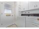 Laundry room area with a washer, dryer, and storage cabinets at 13642 N Silverbell Dr, Sun City, AZ 85351