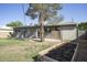 View of backyard, including an outdoor building and a garden bed at 1432 W 7Th St, Tempe, AZ 85281