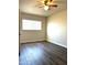 This bedroom features sleek, modern laminate floors and a ceiling fan at 1432 W 7Th St, Tempe, AZ 85281
