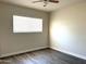 This bedroom features sleek, modern laminate floors and a ceiling fan at 1432 W 7Th St, Tempe, AZ 85281