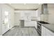 Modern kitchen featuring white cabinetry, stainless steel appliances and gray tile flooring at 1432 W 7Th St, Tempe, AZ 85281