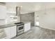 Modern kitchen features white cabinets, stainless appliances, gray flooring, and a functional island at 1432 W 7Th St, Tempe, AZ 85281