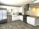 Updated kitchen features white cabinetry, stainless appliances, and sleek gray flooring at 1432 W 7Th St, Tempe, AZ 85281